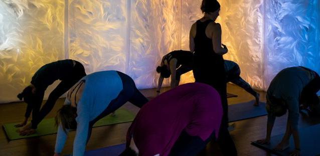 Mai-Fusco (closest to camera) joins  a yoga class surrounded by her art. Photos by Woody Myers